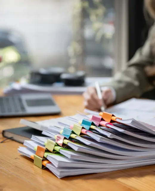 businesswoman-working-in-stacks-of-paper-files-for-2024-12-06-10-38-07-utc